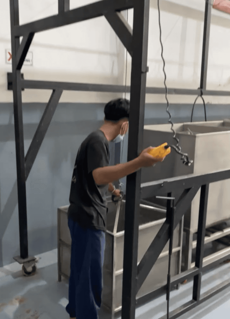Operator using the hoist control during dry spice processing