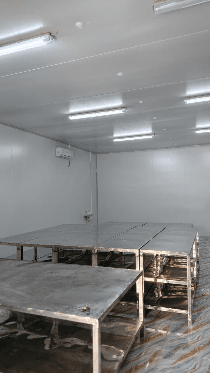 Stainless preparation tables in a hygienic industrial kitchen room
